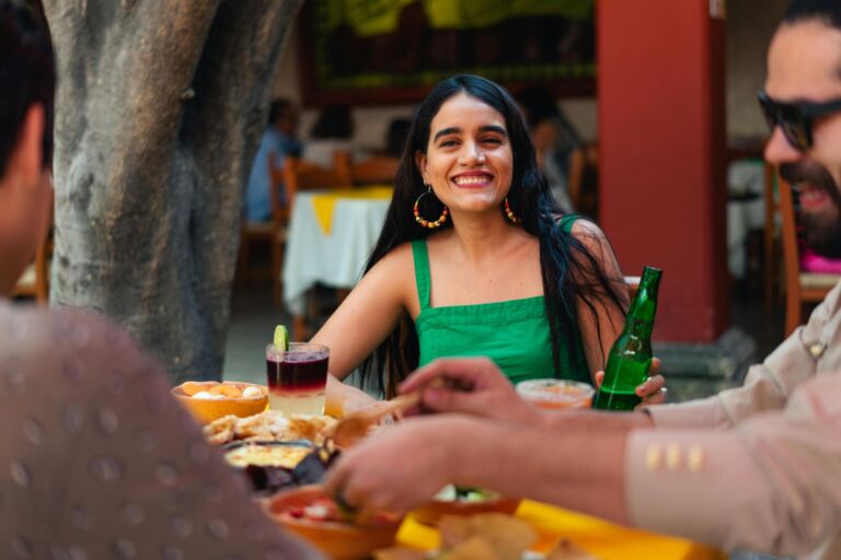 Friends enjoying drinks together at an outdoor table