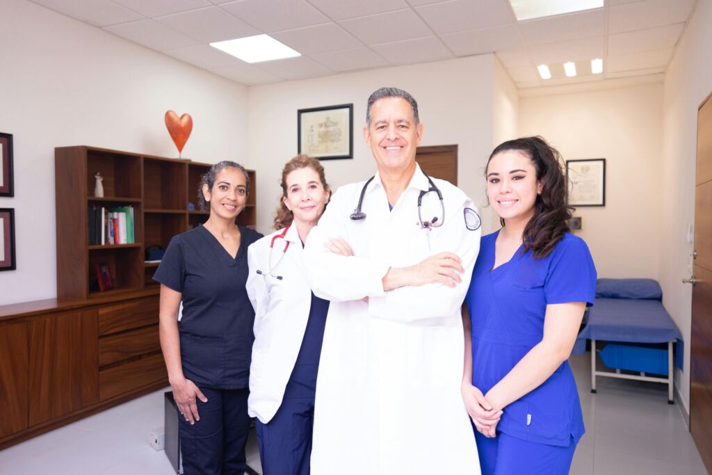 A smiling medical team posing together in a clinic
