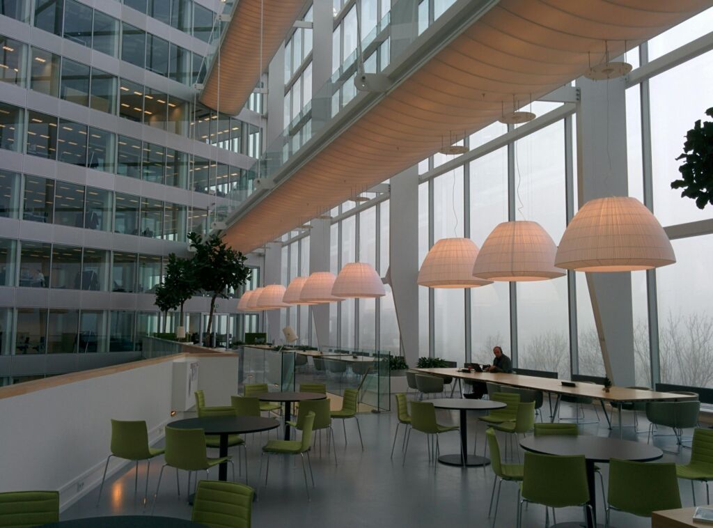 A bright modern office atrium with café seating