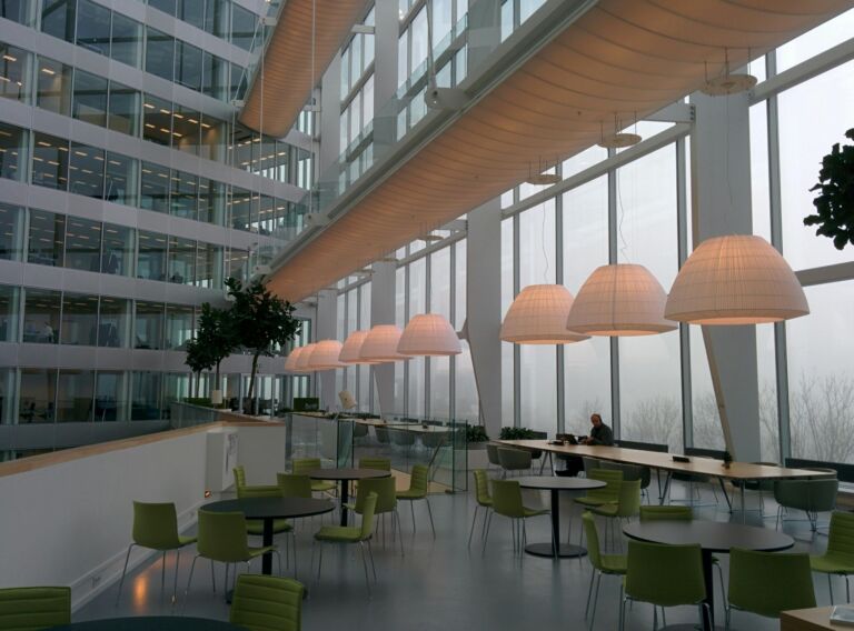 A bright modern office atrium with café seating