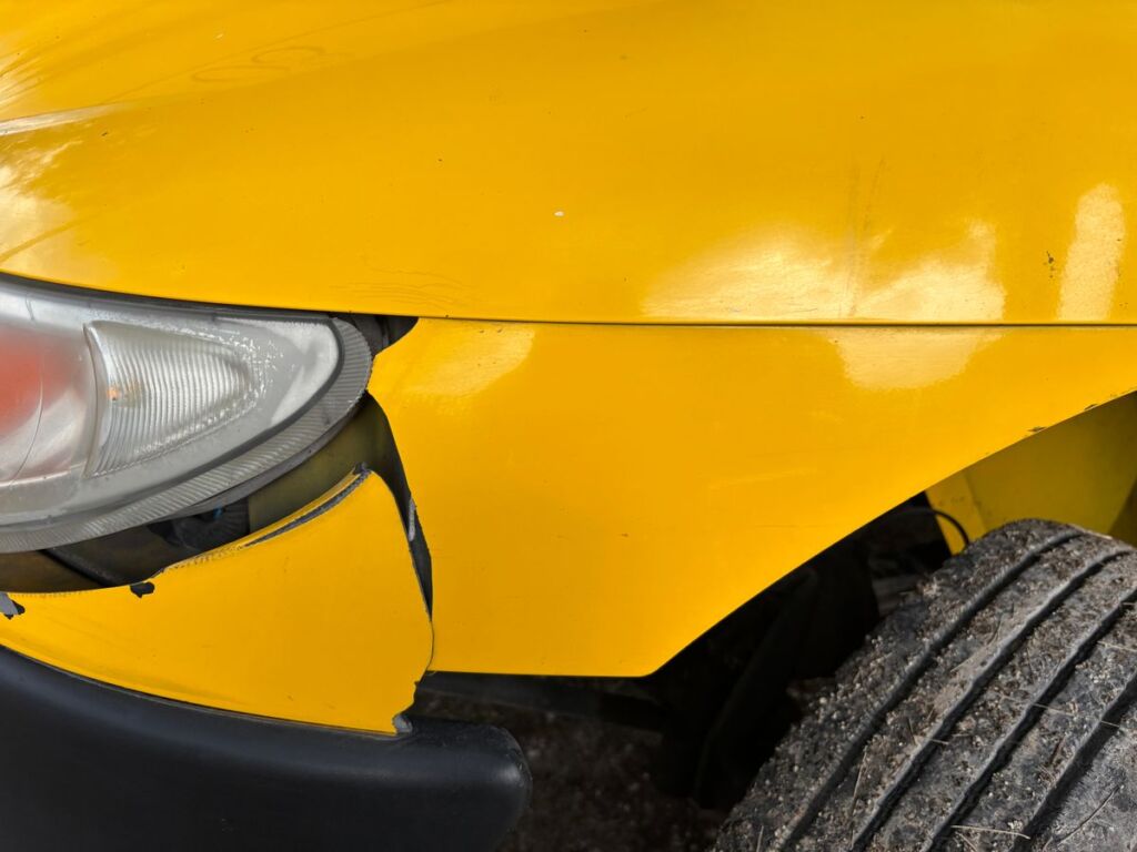 Close-up of a damaged car bumper after an accident