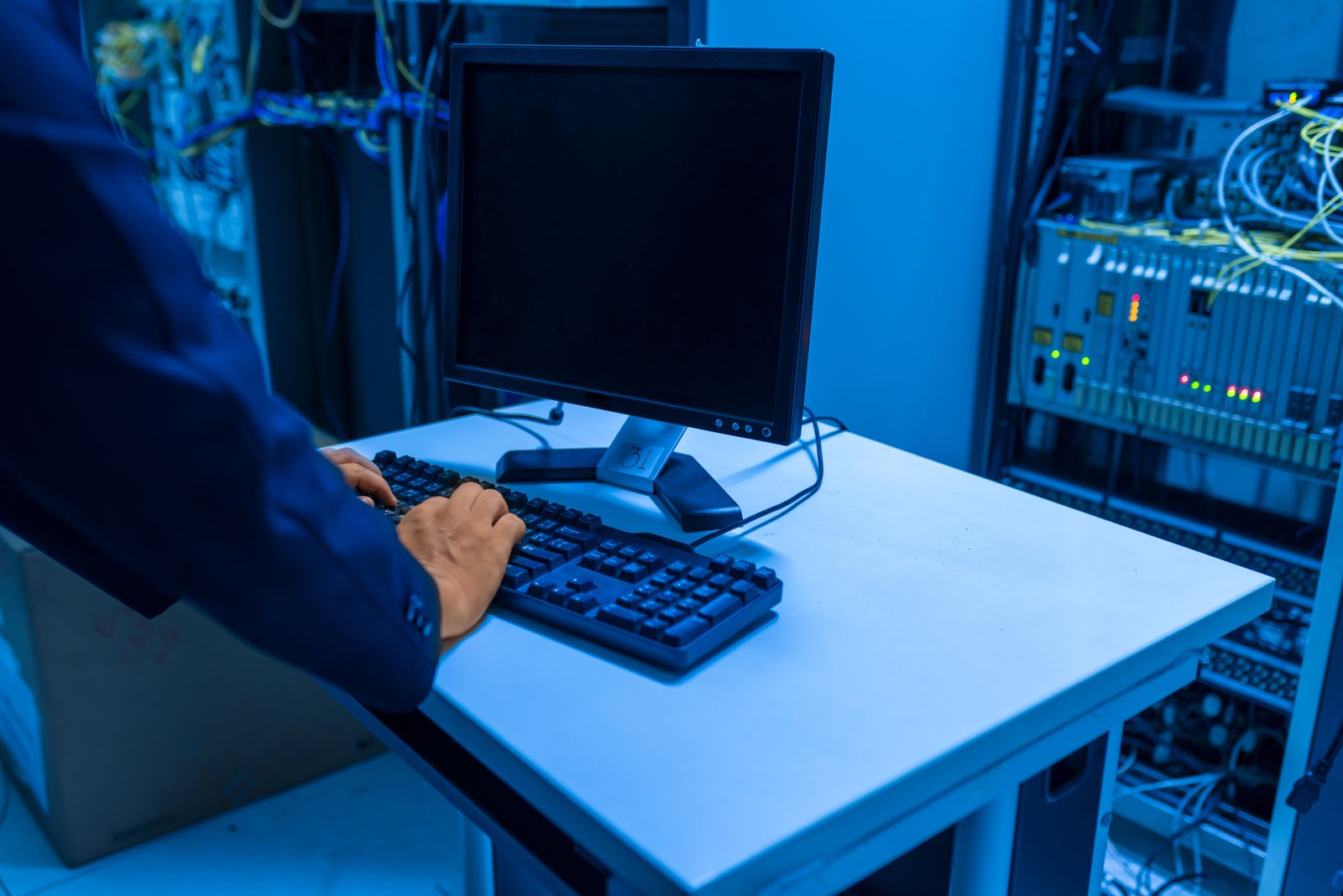 IT technician working in a data center server room