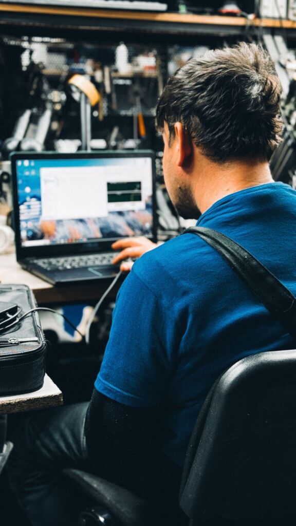 IT support technician working on a laptop