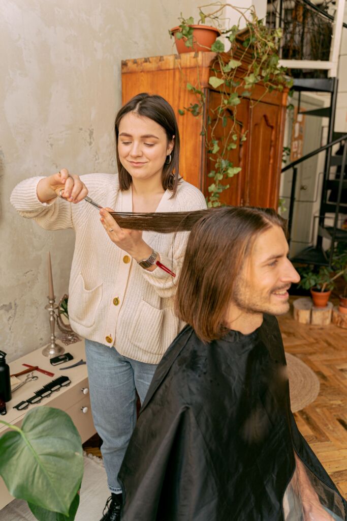 Hair stylist giving a client a haircut in a salon