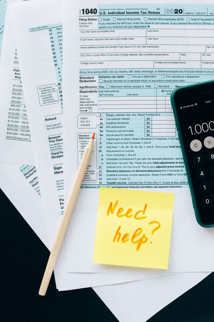 Tax documents and a calculator laid out on a desk during tax preparation