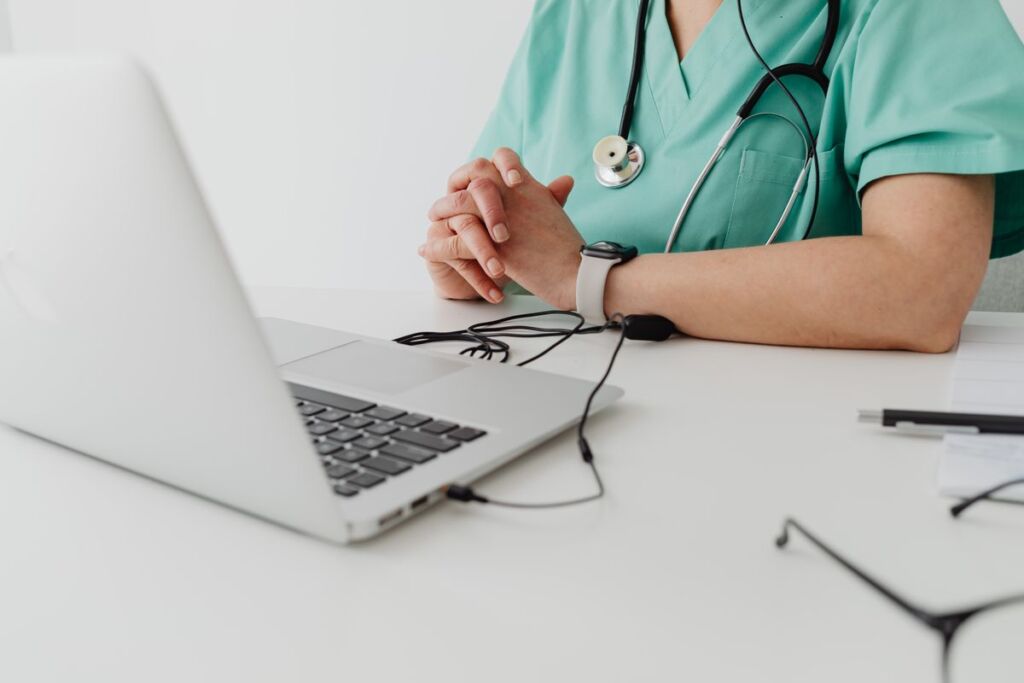 Healthcare worker handling patient records securely on a laptop