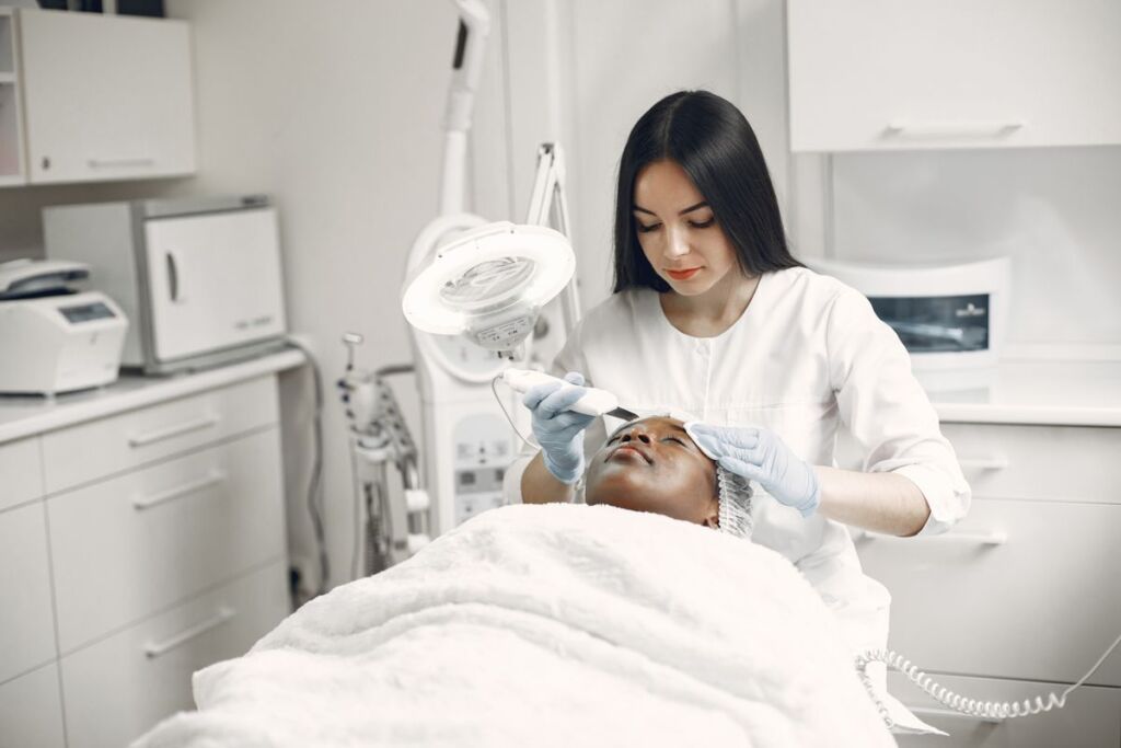 Woman receiving a facial treatment at a beauty and wellness studio