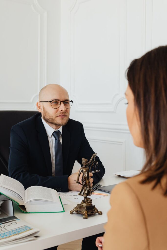 Lawyer explaining case details to two clients in a consultation