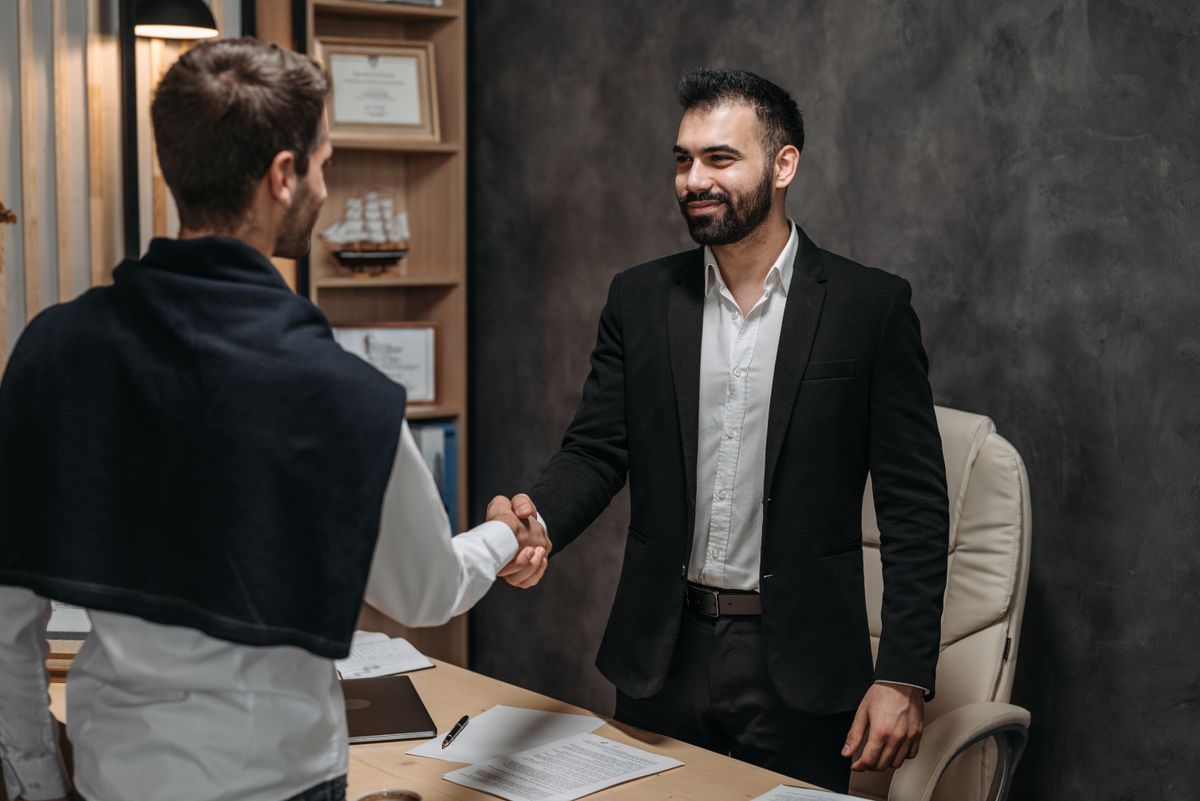 Personal injury attorney meeting with a client across a desk in a law office