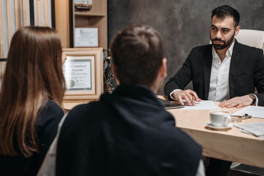 Clients shaking hands with a personal injury lawyer after an intake meeting