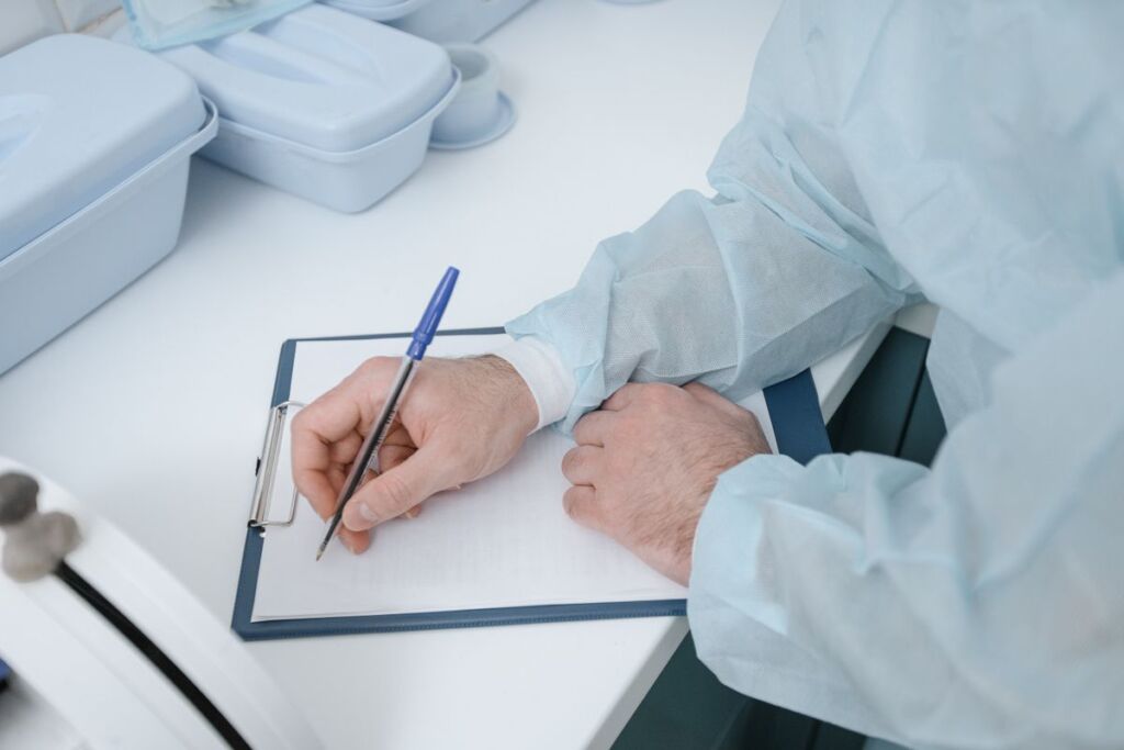 Physician writing notes on a clipboard in a practice