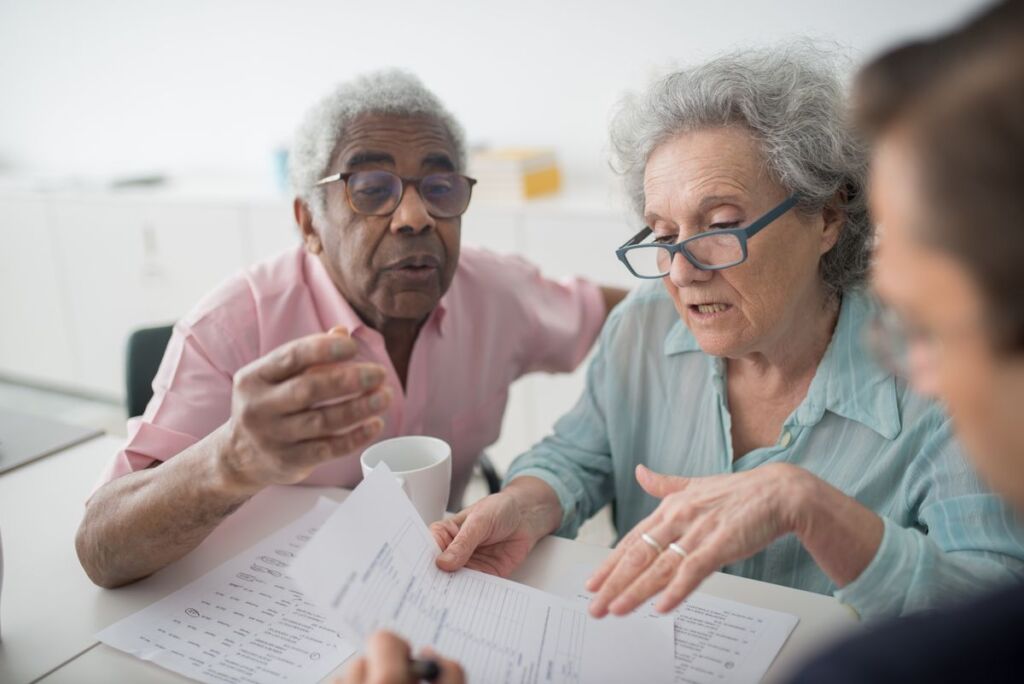 Senior couple reviewing health insurance benefit documents